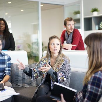 group of young professionals sitting in a meeting