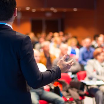 Presenter in front of a crowd