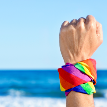 Fist in the air with a rainbow bandana