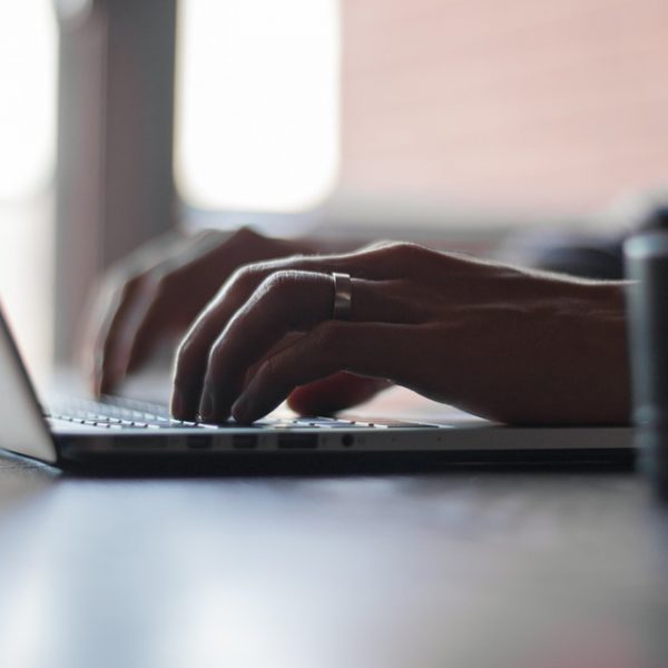 Close up of hands typing on laptop