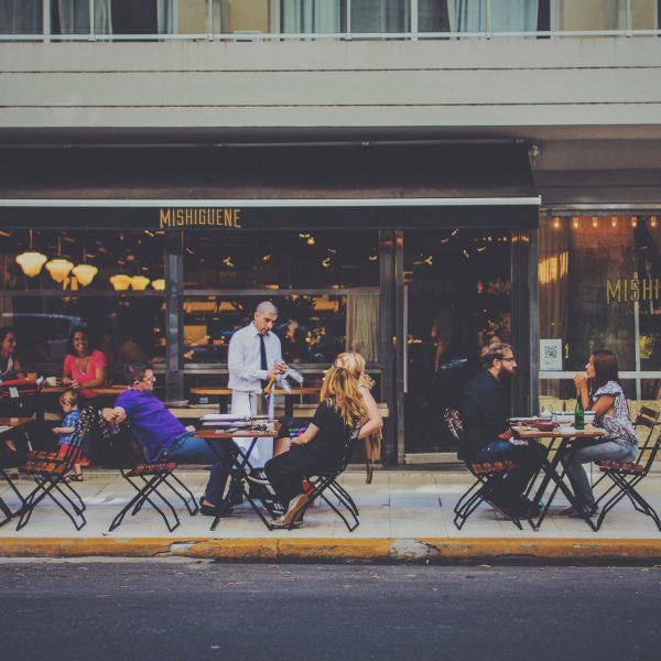 People outside a cafe drinking and eating