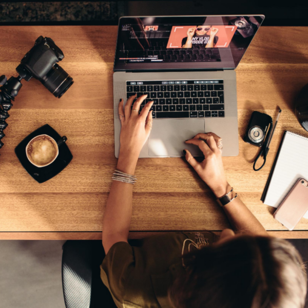 A laptop users sits down to view an online video