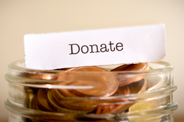 Donate on a piece of paper placed on top of a jar of pennies