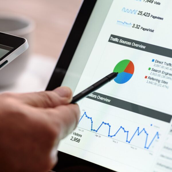 hand pointing to screen with digital marketing graphs