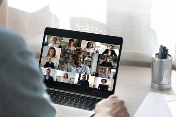 Person at a computer participating in an online meeting