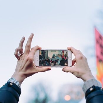 Person taking video footage in a crowd