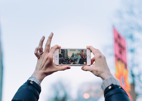 Person taking video footage in a crowd