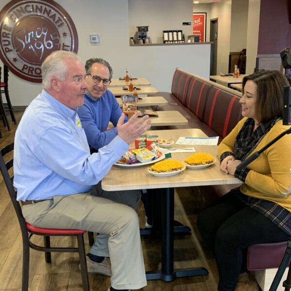 Members of the media sitting around a table eating Gold Star