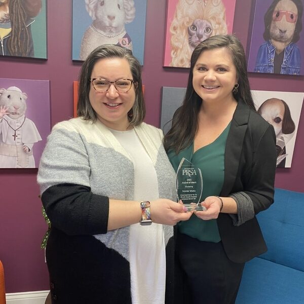 Two women holding a PRSA East Central District Diamond Award