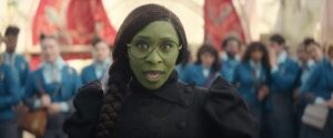 Screenshot of Cynthia Erivo as Elphaba in Wicked Movie First Look Trailer with fellow students standing in the background