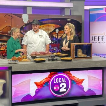 Members of the Jeff Ruby Culinary Entertainment team participating in a live interview in a news studio.