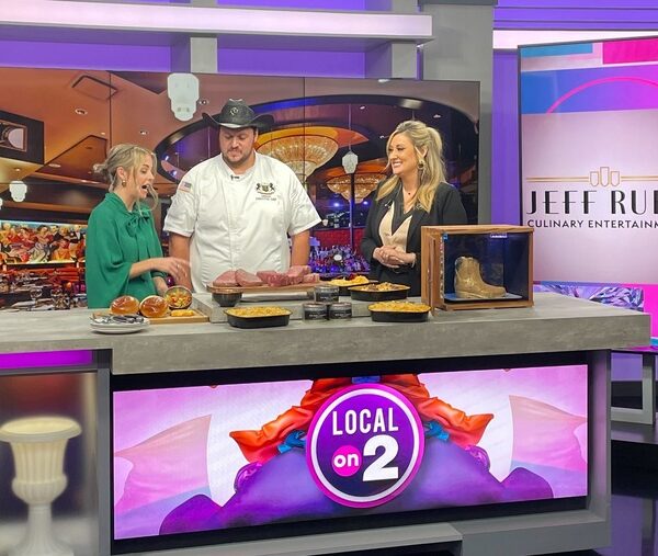 Members of the Jeff Ruby Culinary Entertainment team participating in a live interview in a news studio.